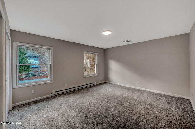 unfurnished room featuring a baseboard radiator and carpet floors