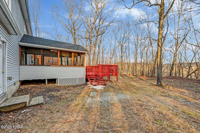 view of yard with a wooden deck and a sunroom