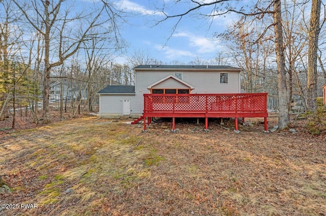 rear view of house featuring a wooden deck