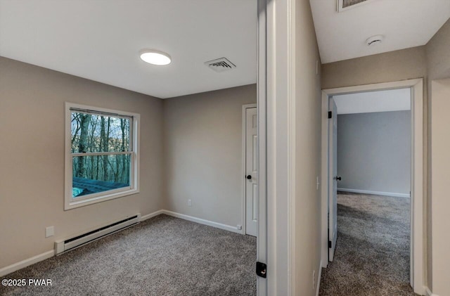 carpeted spare room featuring a baseboard radiator