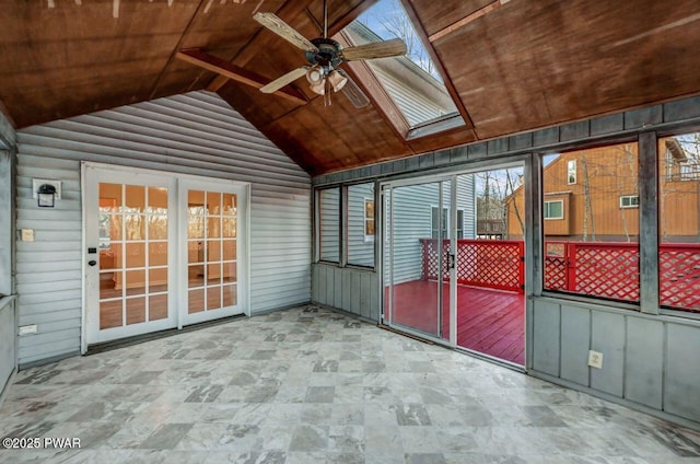 unfurnished sunroom with ceiling fan, lofted ceiling with skylight, a wealth of natural light, and wooden ceiling