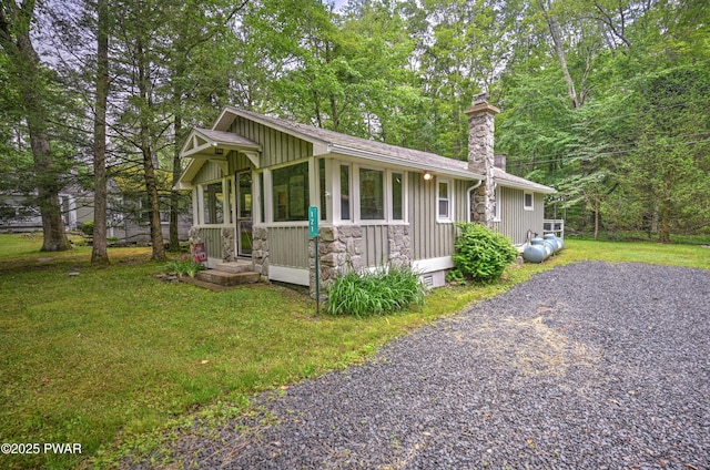 121 Ness Rd, Dingmans Ferry, PA 18328 - view of front of house featuring a chimney, board and batten siding, and a front lawn