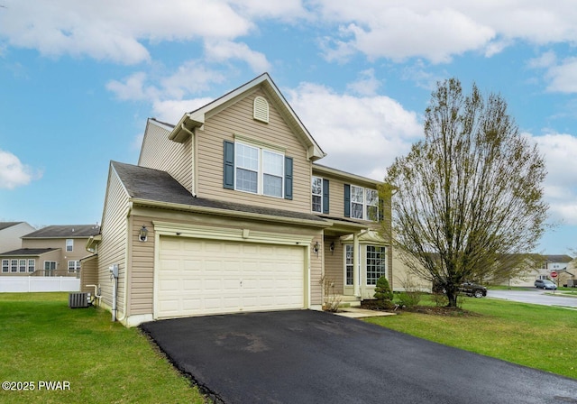 traditional-style house with an attached garage, aphalt driveway, a front yard, central AC, and fence
