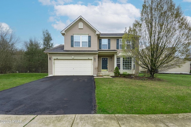 view of front of property featuring a front yard, an attached garage, and aphalt driveway