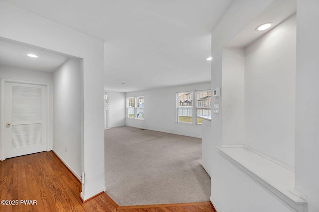corridor with baseboards, carpet, and recessed lighting