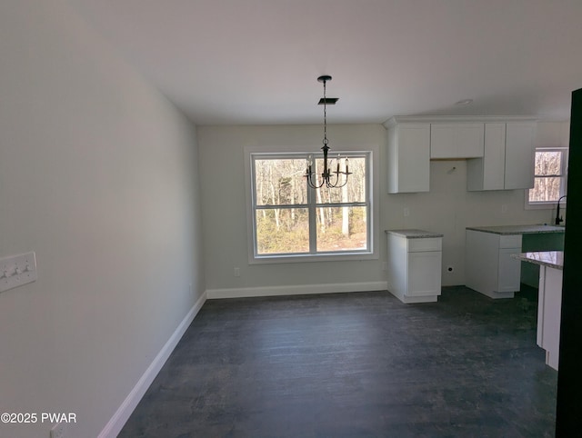 kitchen featuring a chandelier, decorative light fixtures, and white cabinetry