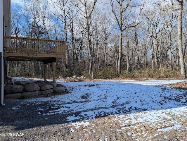 snowy yard featuring a deck