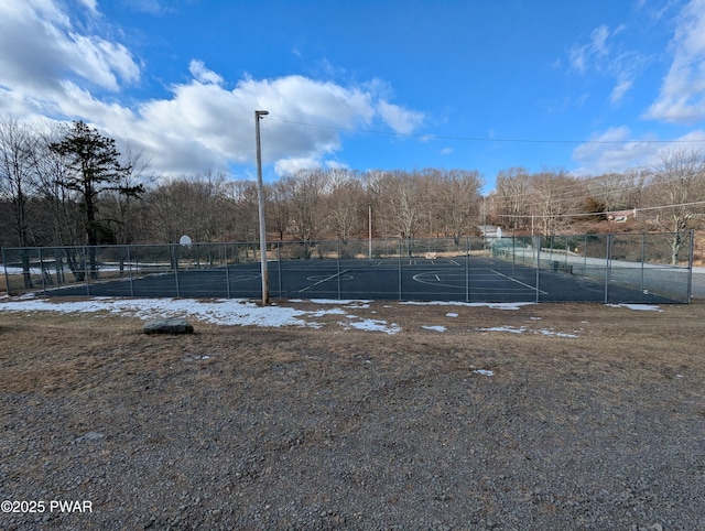 view of tennis court with basketball hoop