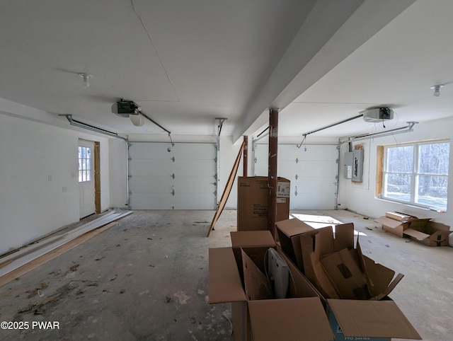 garage featuring electric panel and a garage door opener