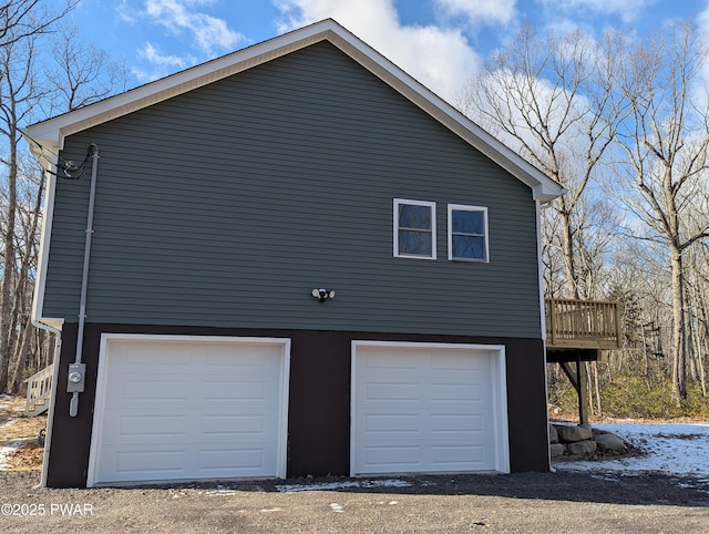 view of side of home featuring a deck and a garage