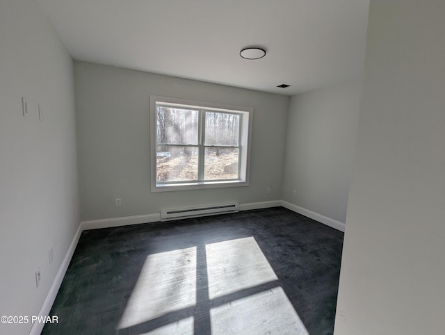 carpeted spare room featuring baseboard heating