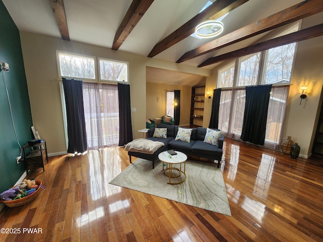 living room with beam ceiling and wood-type flooring