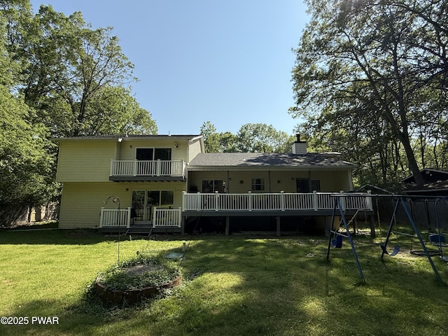 12044 Maplewood Dr, East Stroudsburg, PA 18302 - rear view of house with a playground, a yard, a balcony, and a chimney