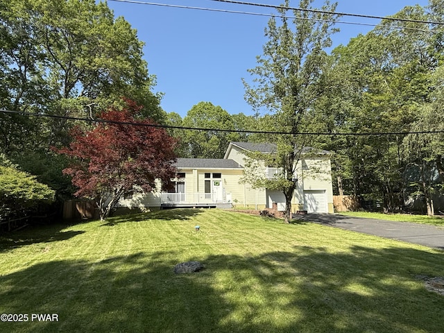 12044 Maplewood Dr, East Stroudsburg, PA 18302 - obstructed view of property with driveway, a front yard, and an attached garage