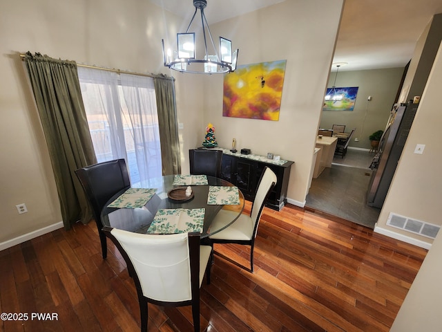 dining room featuring an inviting chandelier and dark hardwood / wood-style floors