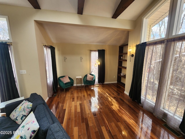 unfurnished living room featuring dark wood-type flooring and lofted ceiling with beams