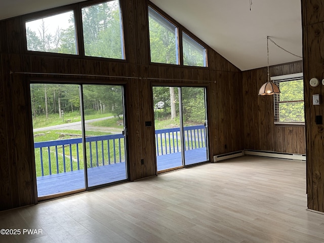 110 Parkwood Dr # 154, Lake Ariel, PA 18436 - empty room featuring wood finished floors, wooden walls, a baseboard radiator, and high vaulted ceiling