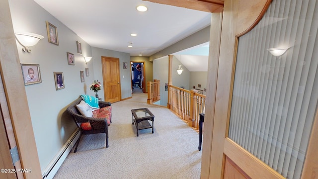 living area with baseboard heating and light colored carpet