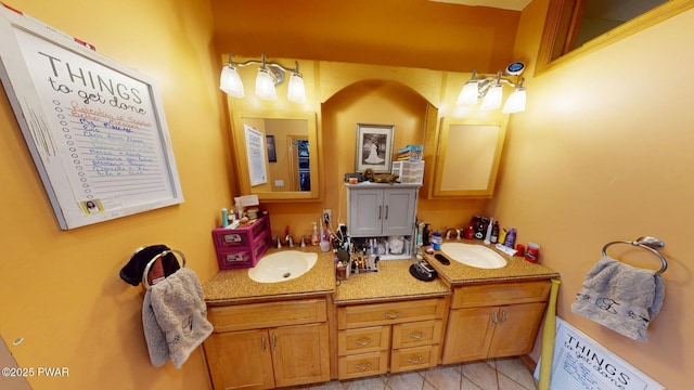 bathroom featuring tile patterned flooring and vanity