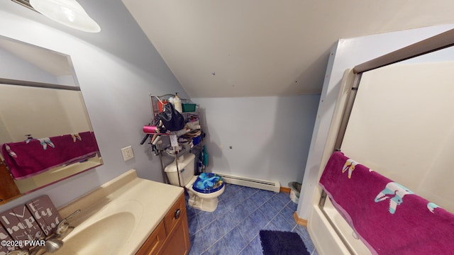 bathroom featuring toilet, vanity, baseboard heating, and vaulted ceiling