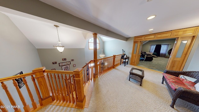 corridor featuring light carpet and vaulted ceiling