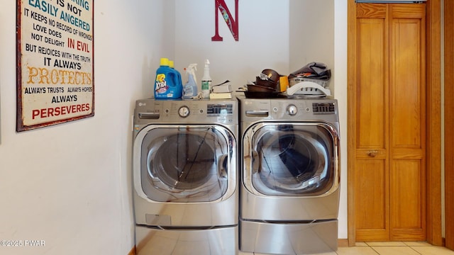 laundry area with separate washer and dryer and light tile patterned floors