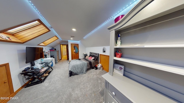 bedroom featuring lofted ceiling with skylight and light carpet