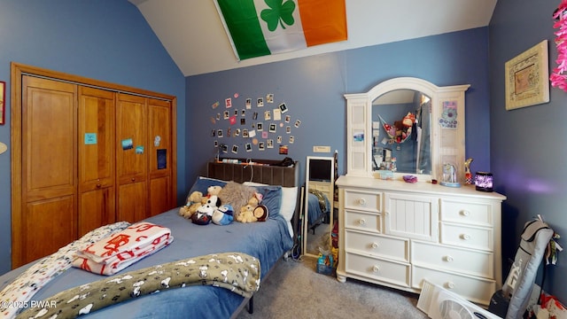 carpeted bedroom featuring a closet and lofted ceiling