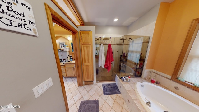 bathroom featuring tile patterned flooring and independent shower and bath