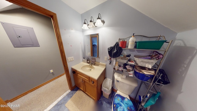 bathroom with electric panel, vanity, lofted ceiling, and toilet