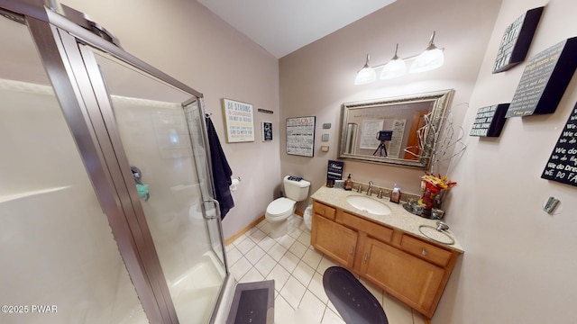 bathroom with tile patterned floors, a shower with door, toilet, and vanity