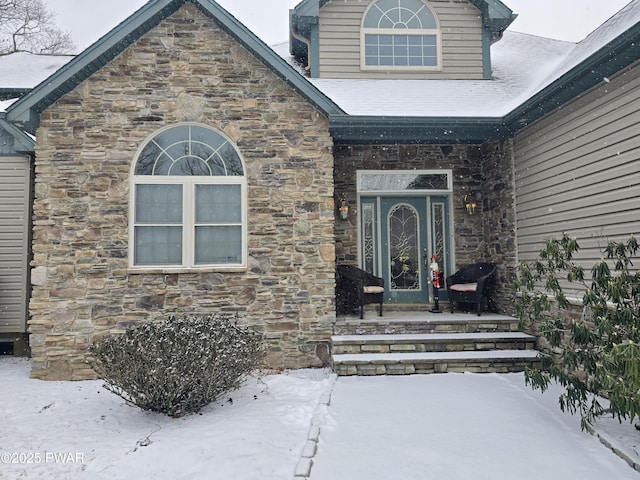 view of snow covered property entrance