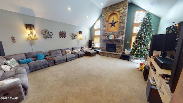 carpeted living room with high vaulted ceiling, plenty of natural light, and a fireplace