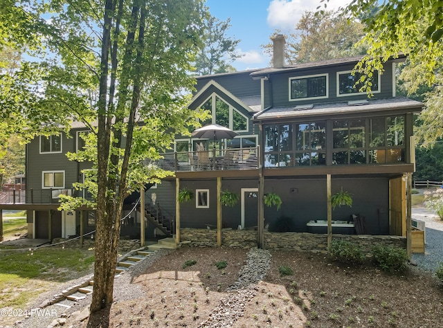 back of house featuring a deck and a sunroom