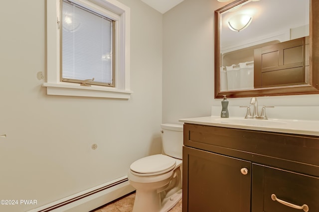 bathroom with tile patterned floors, vanity, toilet, and a baseboard radiator