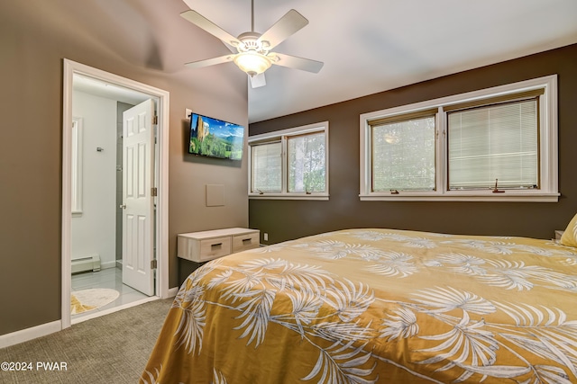 carpeted bedroom with ensuite bath, ceiling fan, and a baseboard heating unit