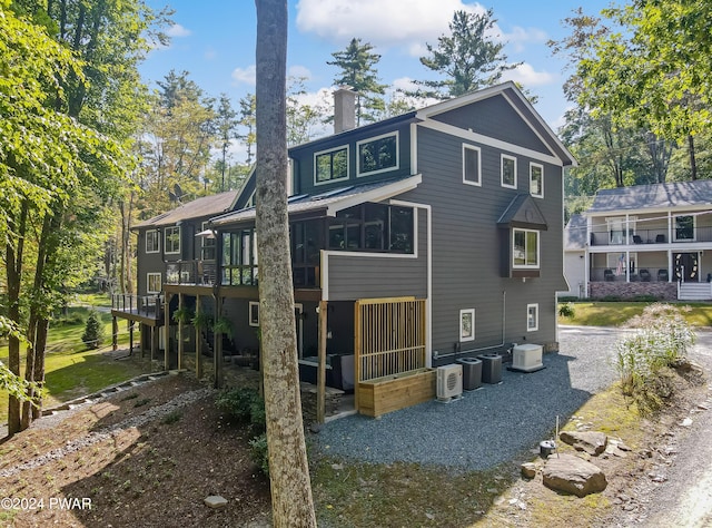 back of property with cooling unit and a deck