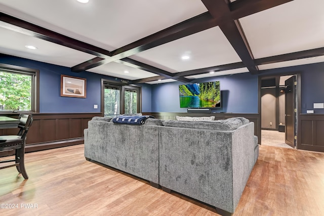 living room featuring beam ceiling, light hardwood / wood-style floors, and a baseboard heating unit