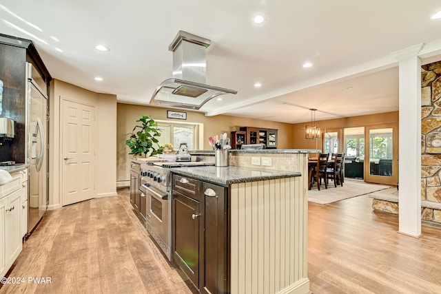 kitchen featuring island exhaust hood, high end appliances, a healthy amount of sunlight, decorative light fixtures, and a center island