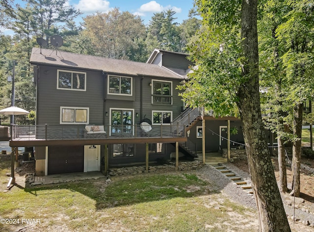 view of front facade featuring central AC unit, a garage, a deck, and a front yard