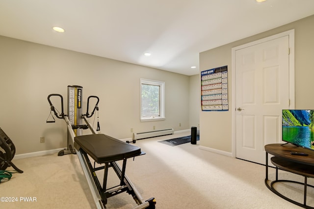 workout area featuring light colored carpet and a baseboard heating unit