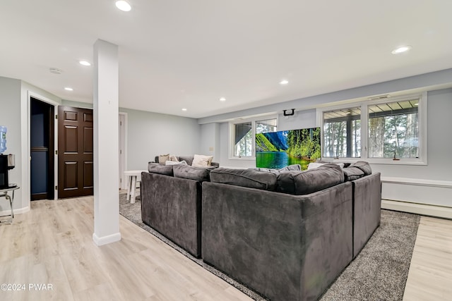 living room featuring baseboard heating and light hardwood / wood-style flooring