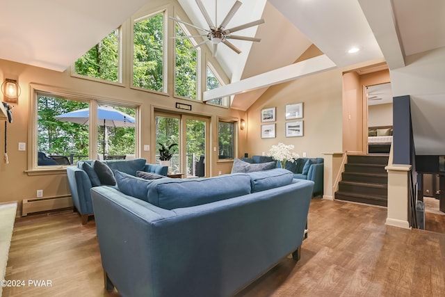 living room with baseboard heating, ceiling fan, high vaulted ceiling, and wood-type flooring