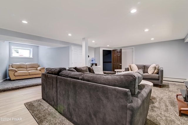 living room featuring baseboard heating and light hardwood / wood-style floors