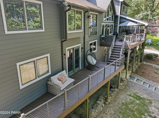 back of property featuring a wooden deck