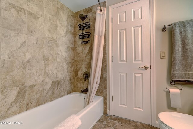 bathroom with shower / bath combo and toilet