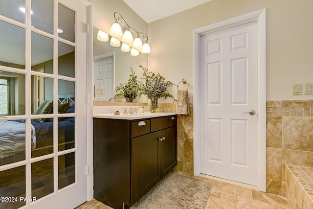 bathroom featuring vanity and tile walls