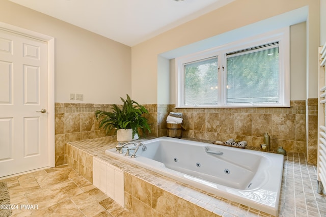 bathroom featuring a relaxing tiled tub