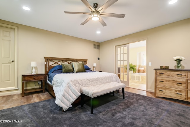 bedroom with ensuite bath, ceiling fan, and dark wood-type flooring