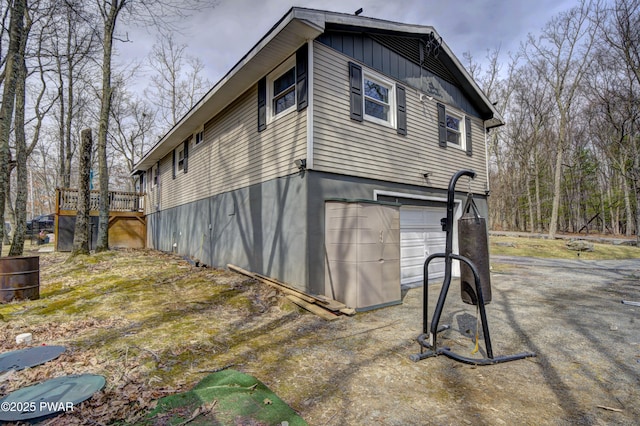 view of side of property featuring a deck and a garage